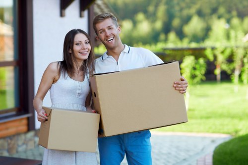 Local movers loading furniture into a van for an Officeremovals relocation