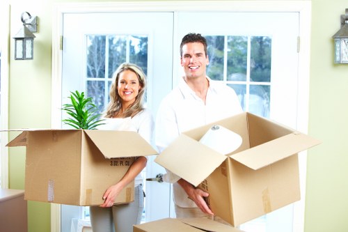 Trained movers using safe lifting techniques during a removal