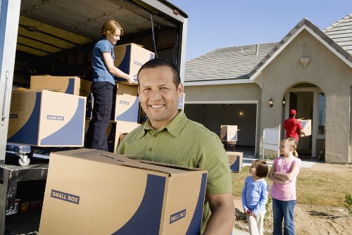 Removal crew preparing items for transport on moving day